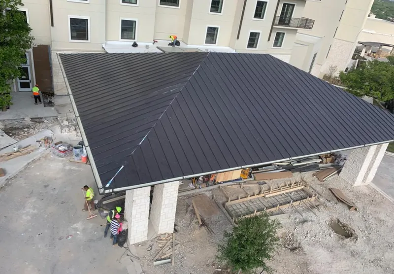 Metal roofing installation team working on a commercial building in Marion